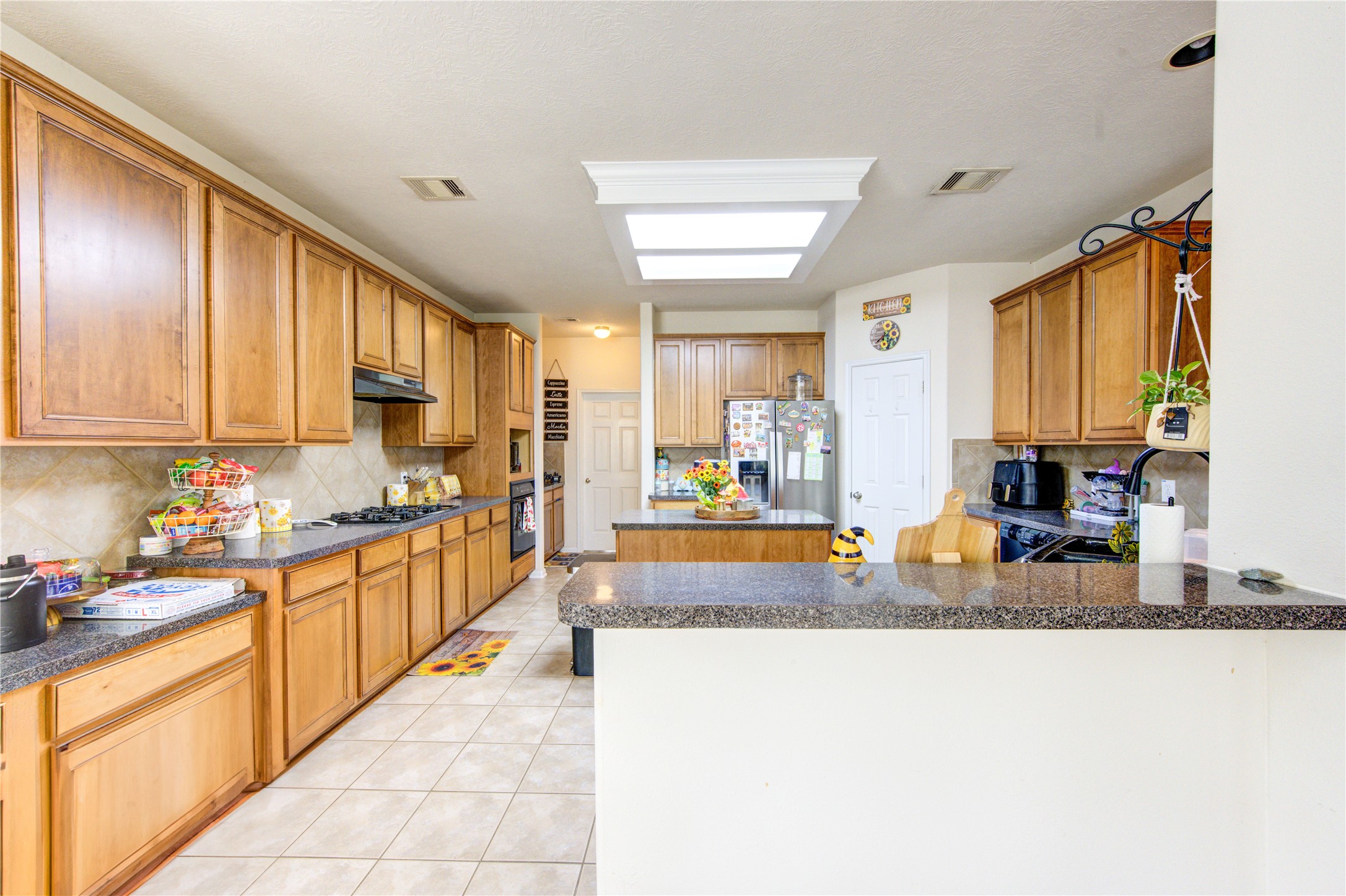 24811 Corbin Gate Drive Spring, TX 77389 - Photo 13 of 32 a large kitchen with stainless steel appliances granite countertop a sink and cabinets