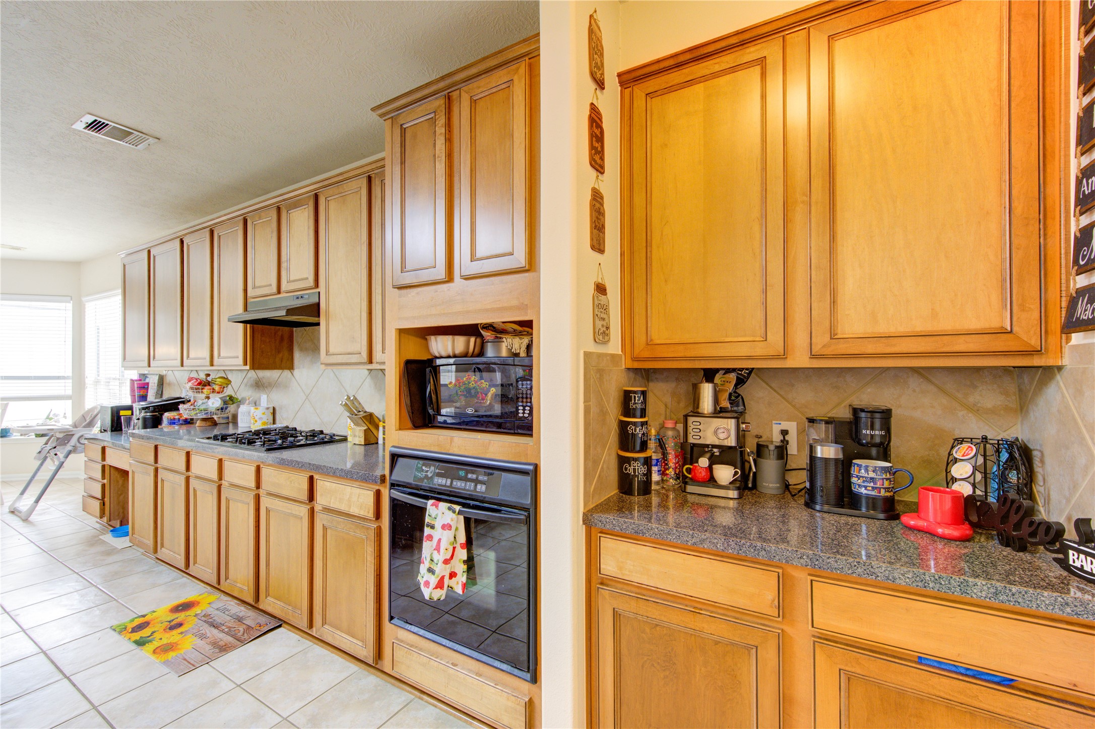 24811 Corbin Gate Drive Spring, TX 77389 - Photo 14 of 32 a kitchen with stainless steel appliances a stove a sink and cabinets