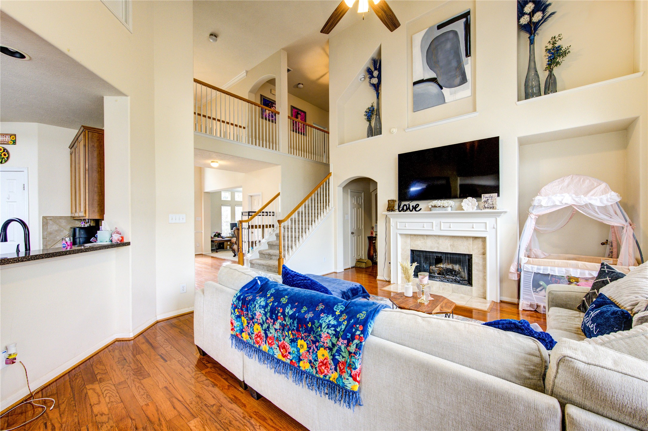 24811 Corbin Gate Drive Spring, TX 77389 - Photo 32 of 32 a living room with furniture a flat screen tv and a fireplace