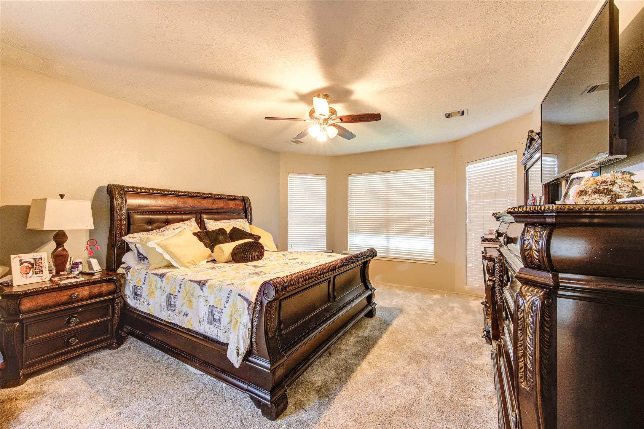 24811 Corbin Gate Drive Spring, TX 77389 - Photo 19 of 32 a bedroom with a bed and a chandelier