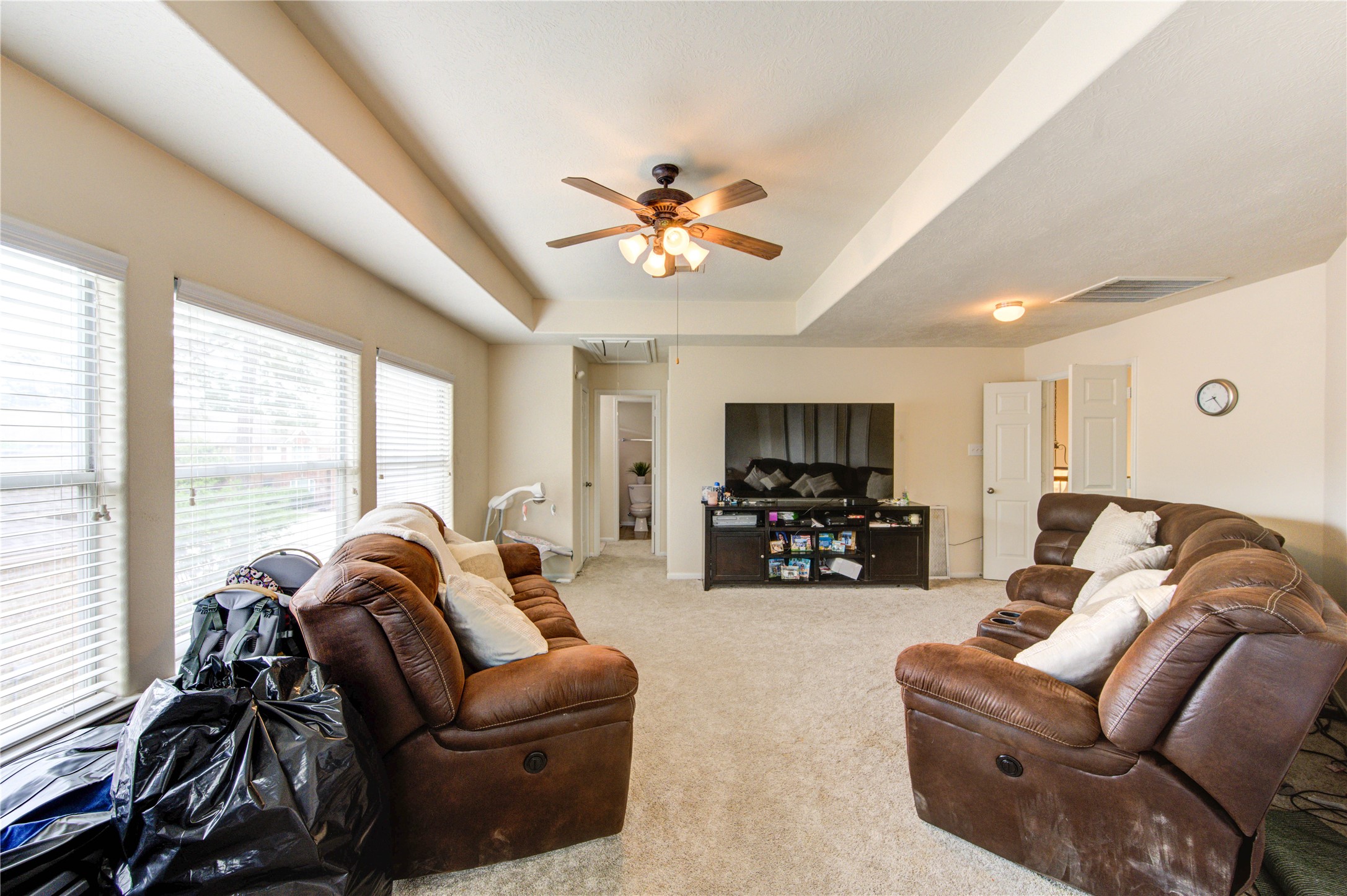 24811 Corbin Gate Drive Spring, TX 77389 - Photo 25 of 32 a living room with furniture a ceiling fan and a flat screen tv