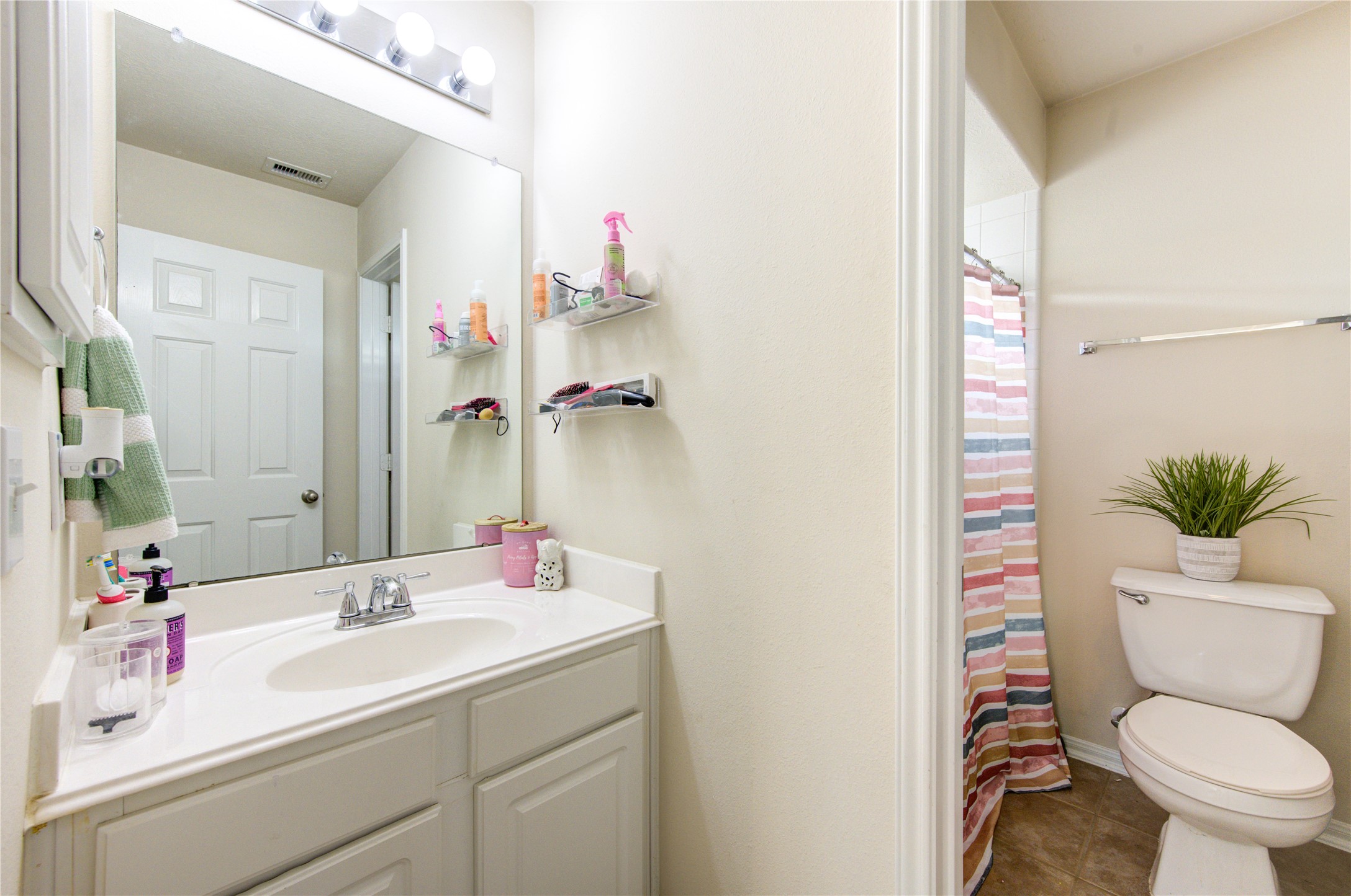 24811 Corbin Gate Drive Spring, TX 77389 - Photo 29 of 32 a bathroom with a sink mirror vanity and toilet