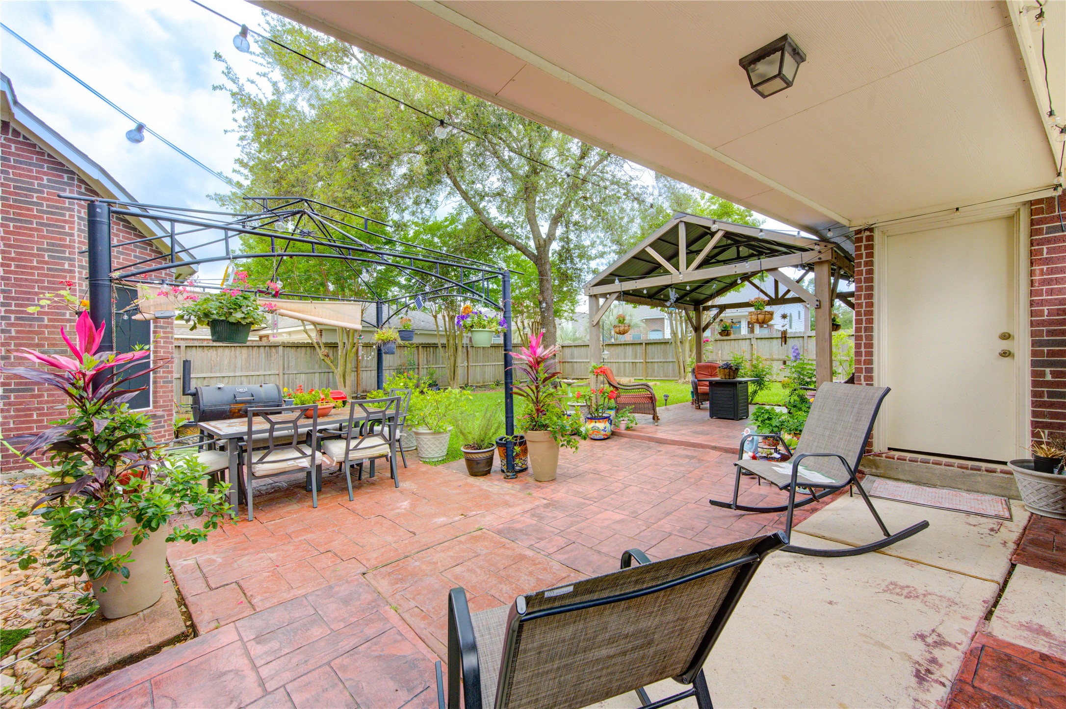 24811 Corbin Gate Drive Spring, TX 77389 - Photo 30 of 32 a view of a patio with a table and chairs and potted plants