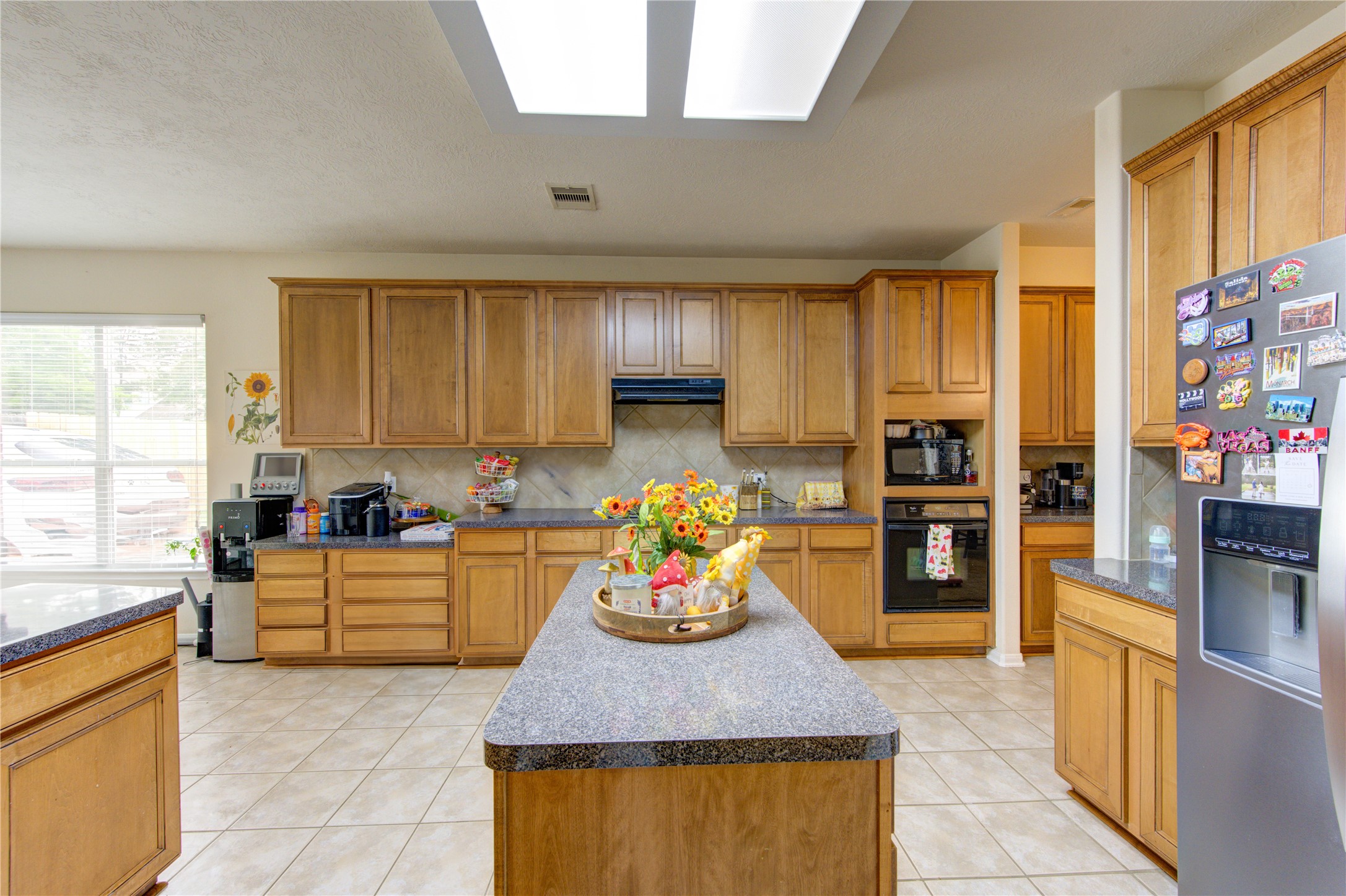24811 Corbin Gate Drive Spring, TX 77389 - Photo 10 of 32 a kitchen with stainless steel appliances granite countertop a sink counter space and a window