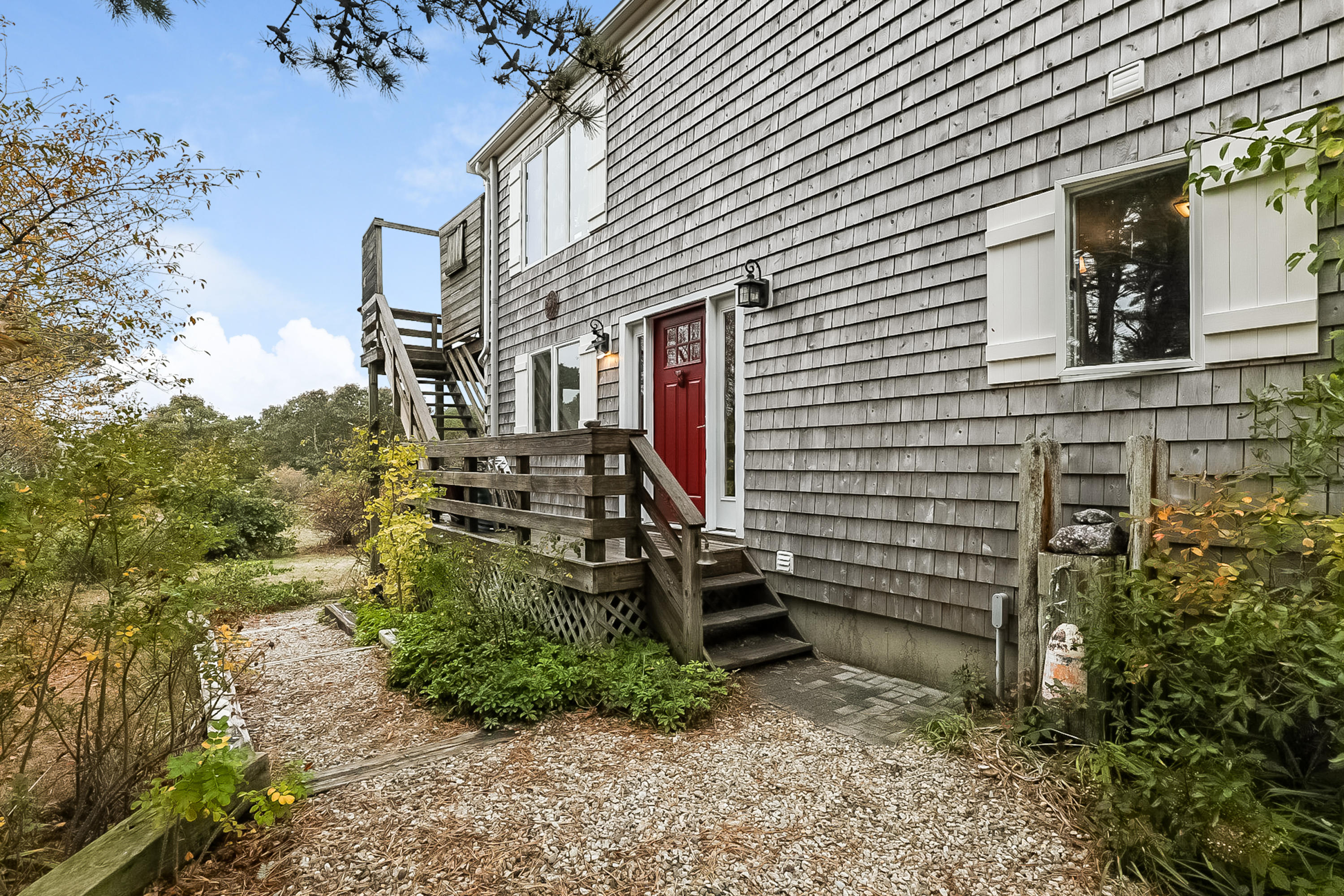 136 Shore Road Truro, MA 02666 - Photo 3 of 21 a view of a house with a yard and sitting area