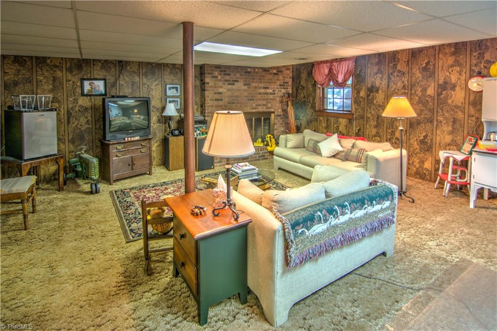 1596 Beckner Road Lexington, NC 27292 - Photo 29 of 29 Large den in basement has wood burning fireplace & is a great spot for lounging or unexpected guests! Basement also has bonus room with walk-in closet, half bath & utility room.