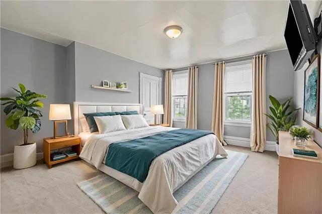 a living room with furniture tv and a large window