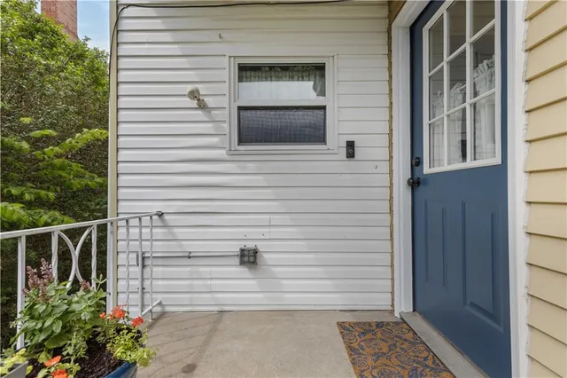 a view of entryway with a window and wooden floor