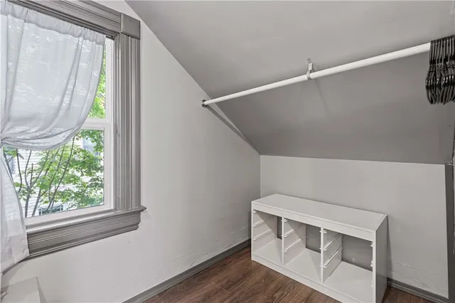 a workspace room with wooden floor furniture and entryway