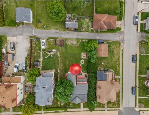 a view of house with a yard and potted plants