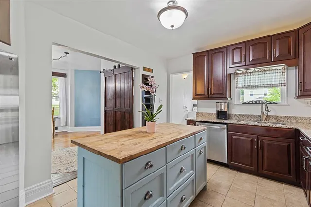 a living room with stainless steel appliances kitchen island granite countertop furniture and a kitchen view