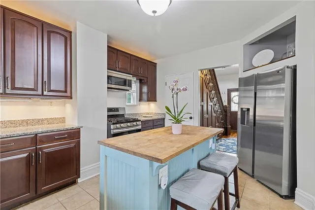 a kitchen with granite countertop a stove and a sink