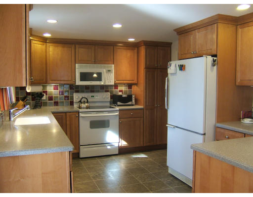 1 Frances Road Lexington, MA 02421 - Photo 4 of 10 a kitchen with a refrigerator a stove top oven and a sink
