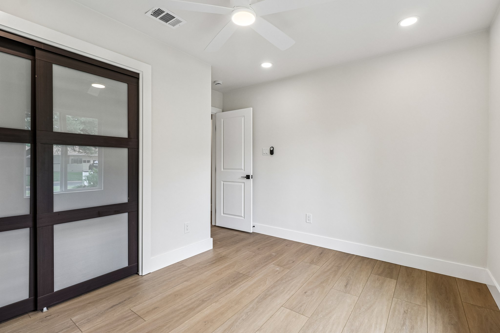 11809 Charing Cross Road Austin, TX 78759 - Photo 18 of 34 Bright hardwood floors and recessed lighting elevate this versatile living space.
