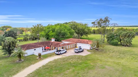 a view of a house with yard furniture and a yard