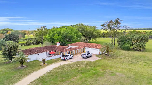 a view of a house with yard furniture and a yard