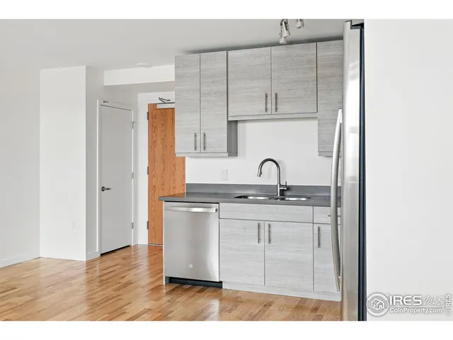 a kitchen with granite countertop a sink and cabinets