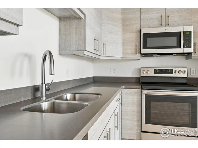 a kitchen with stainless steel appliances granite countertop a stove and a microwave