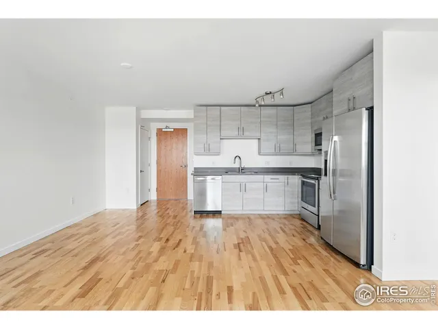 a kitchen with granite countertop white cabinets and stainless steel appliances