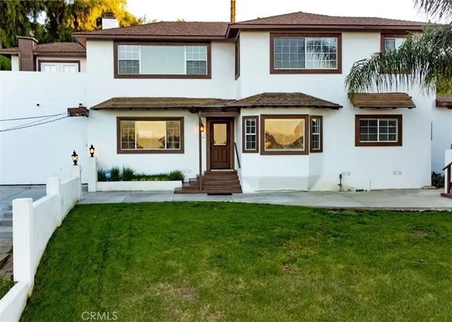 a front view of a house with a yard