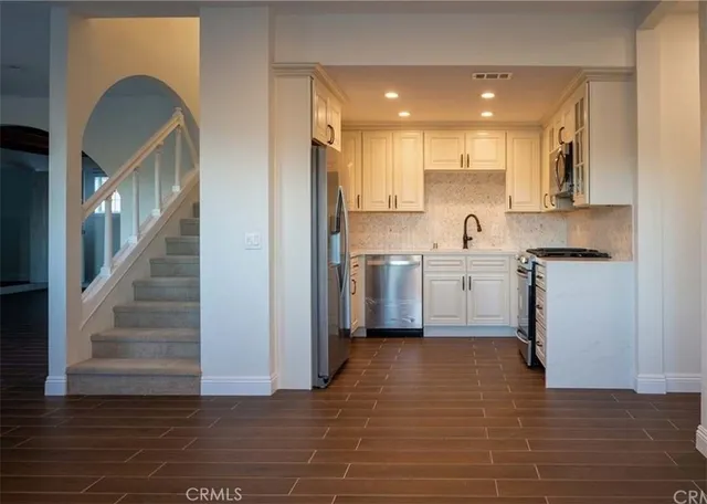 a kitchen with cabinets and a refrigerator