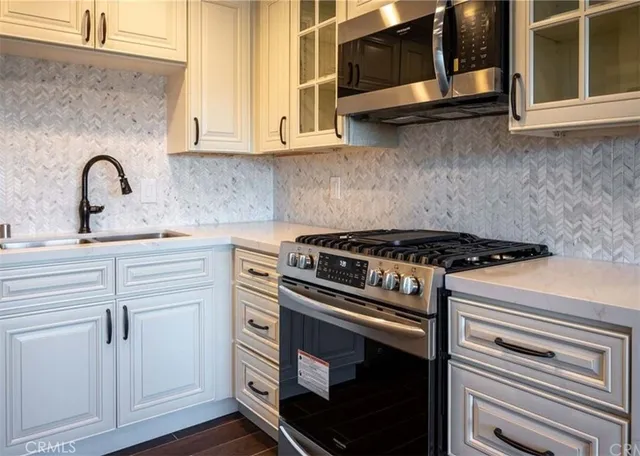 a view of a kitchen with wooden floor and a sink