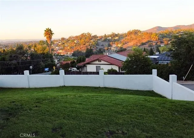 a view of a house with a yard and a sitting area