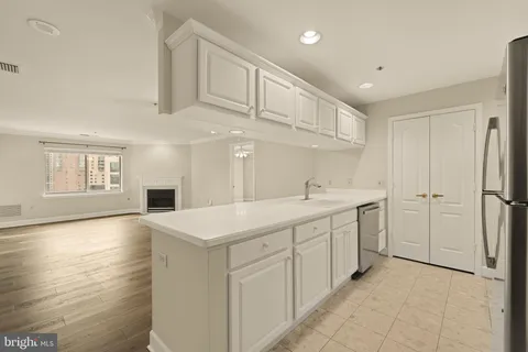 a kitchen with a sink a stove and cabinets