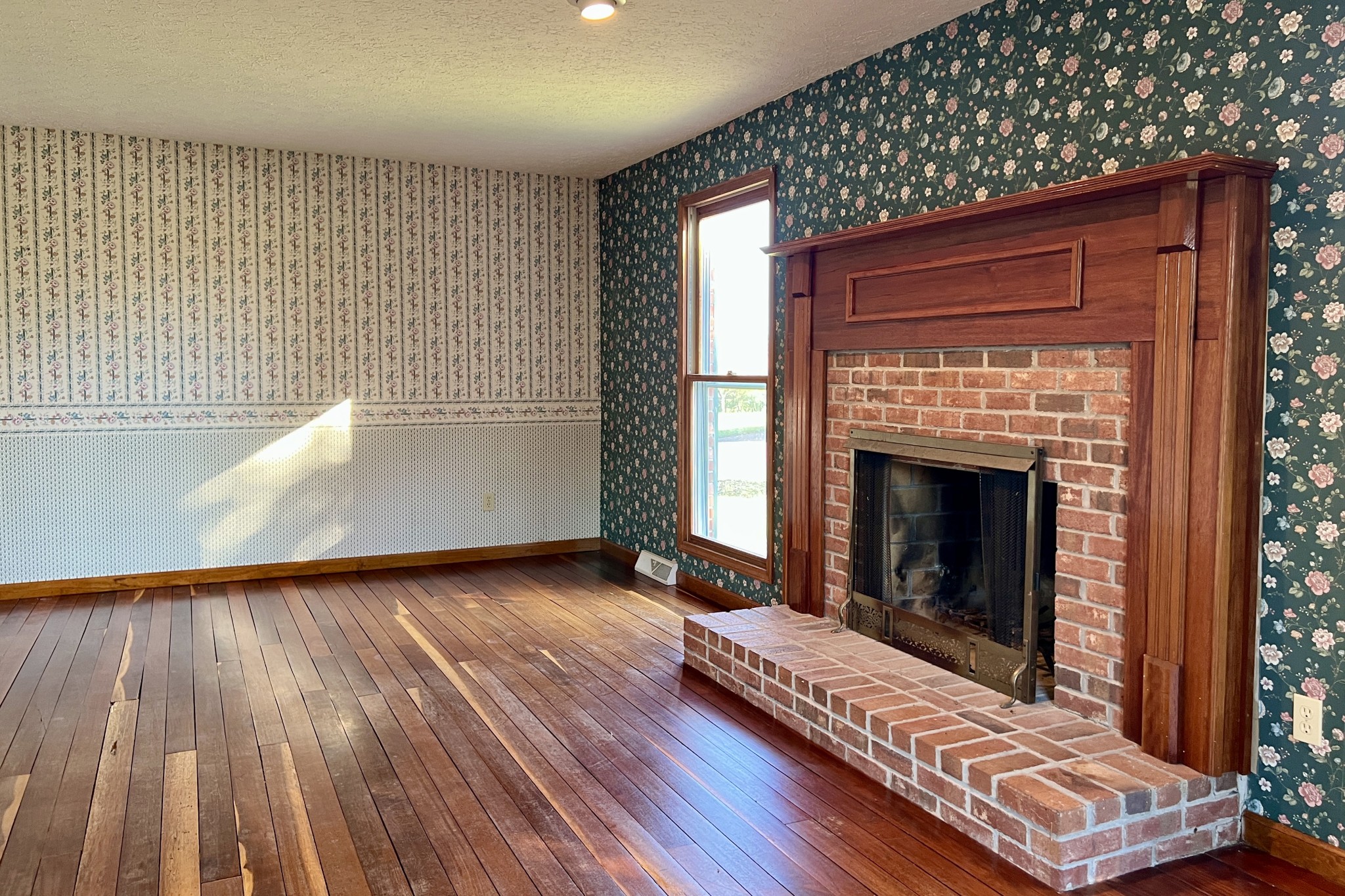 1015 Salem Road Franklin, KY 42134 - Photo 7 of 61 a view of an empty room with wooden floor fireplace and a window