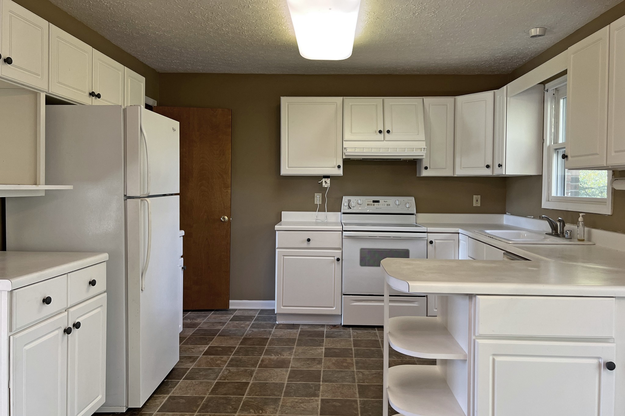 1015 Salem Road Franklin, KY 42134 - Photo 9 of 61 a kitchen with a sink a stove a refrigerator and cabinets