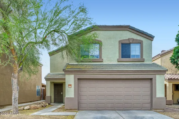 a front view of a house with garage