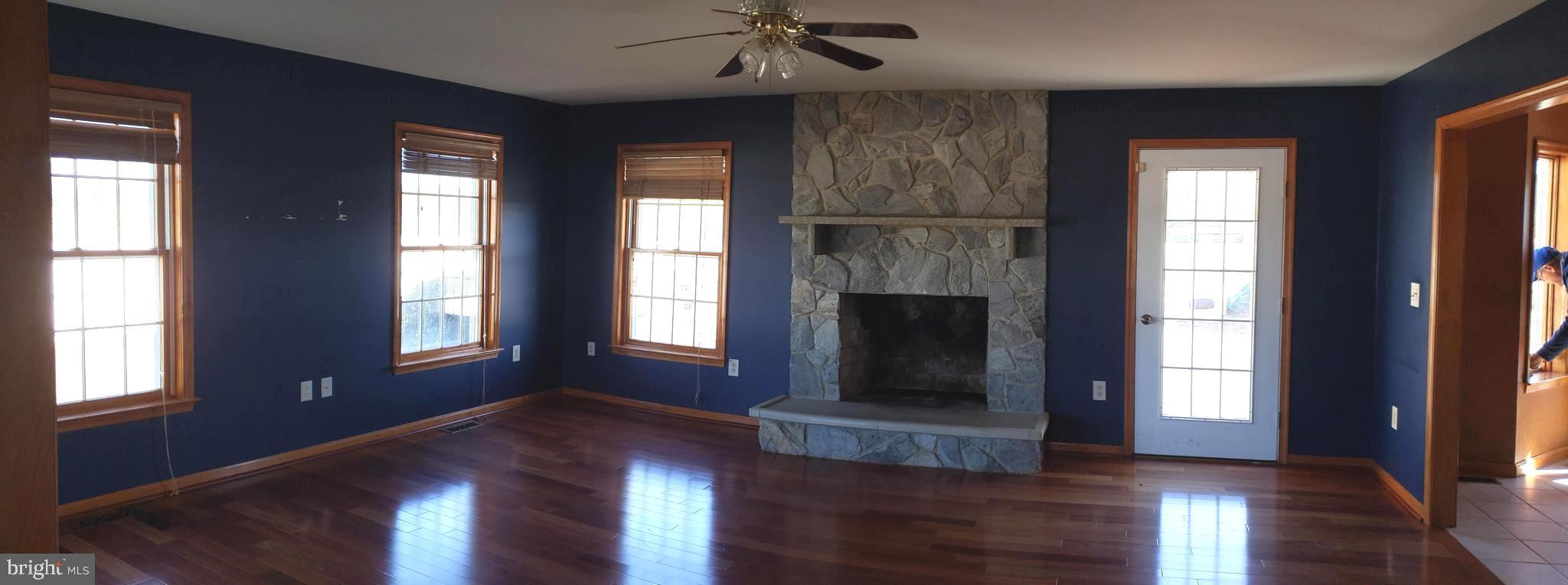 2031 Peters Corner Road Marydel, MD 21649 - Photo 18 of 45 living room with cherry floors and fireplace