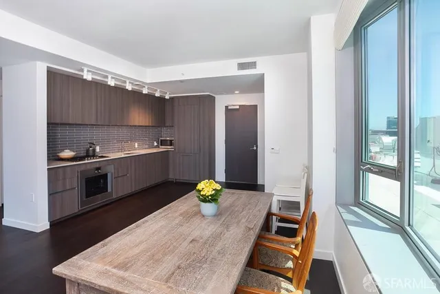 a kitchen with wooden cabinets and stainless steel appliances
