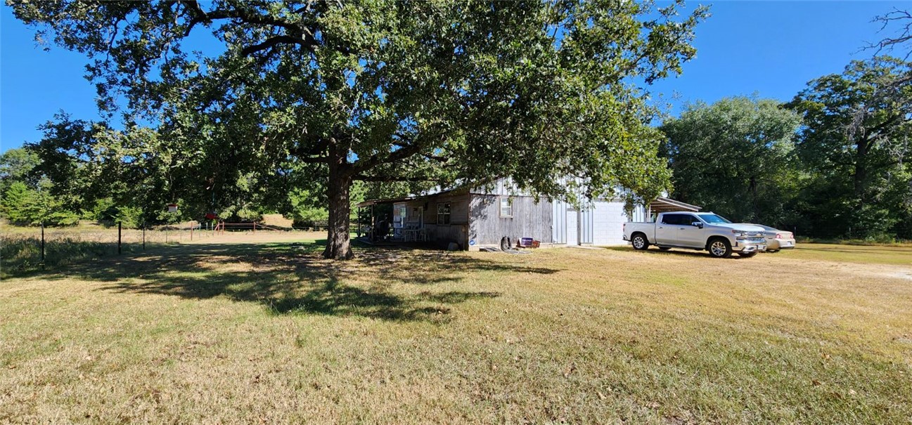a car parked in front of house with trees