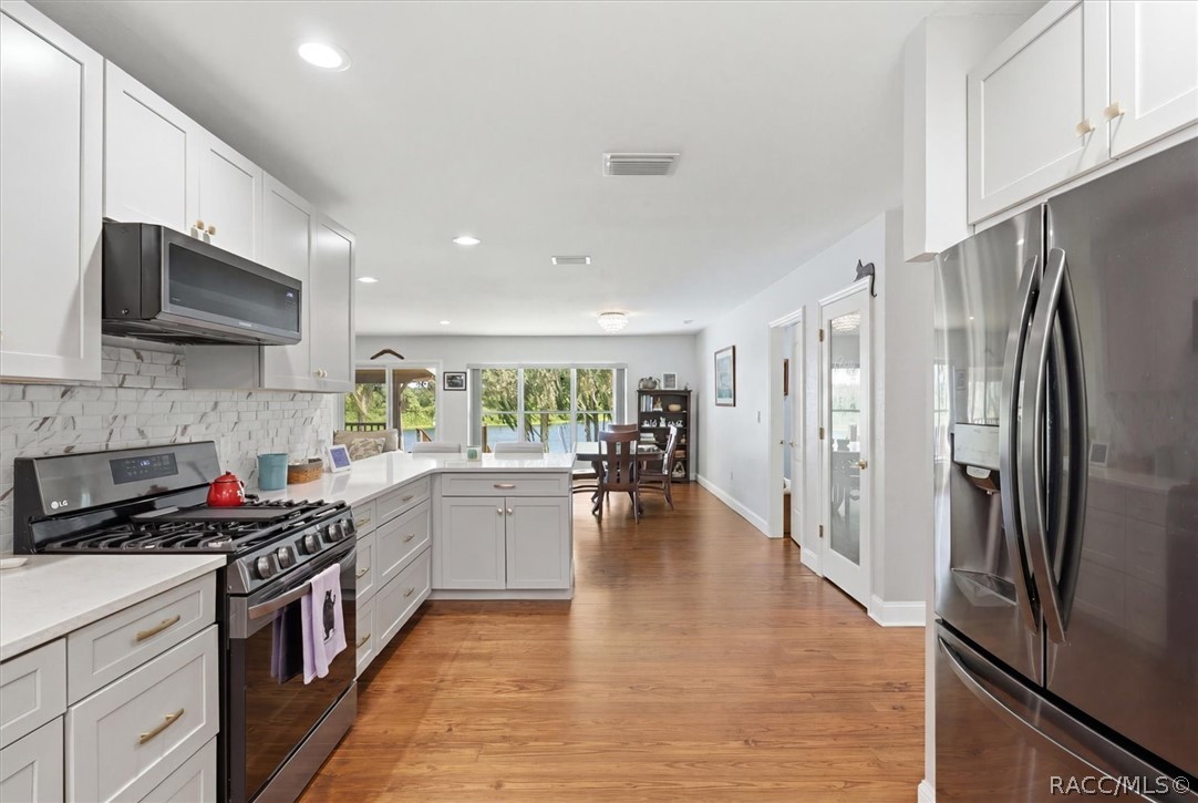 4099 West Ridge Court Dunnellon, FL 34433 - Photo 20 of 49 Don't want you to miss any of the views from this kitchen. Notice glass door on right? Leads to a nice pantry for more storage.