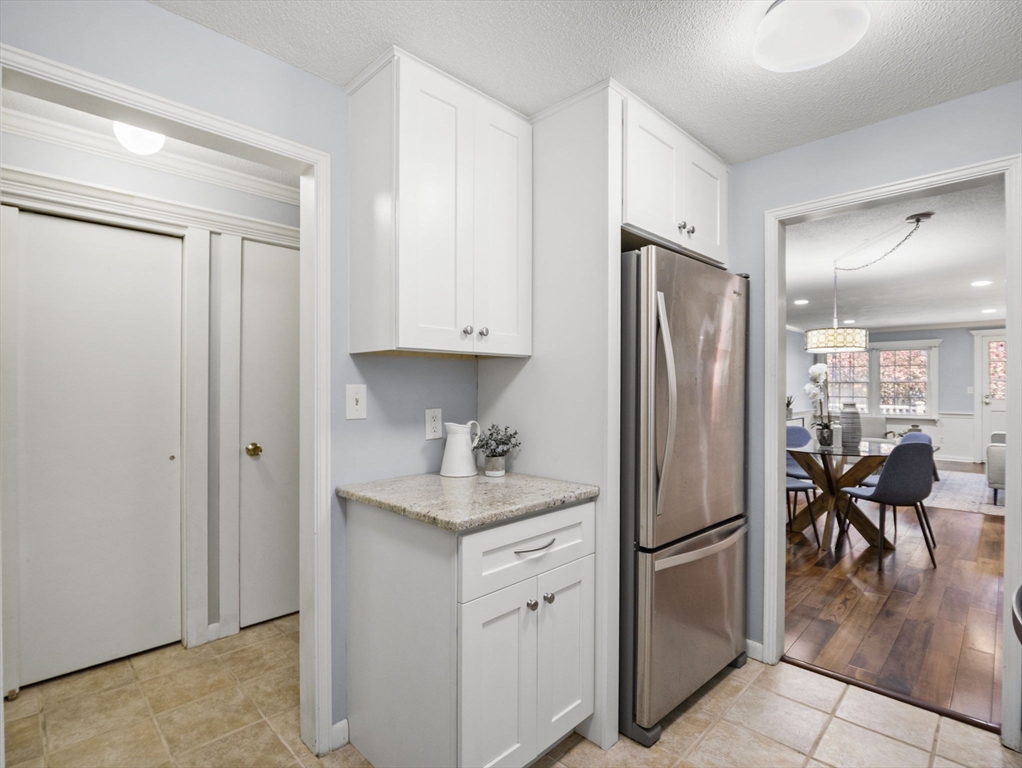 9 Elm Street, Unit 1 Acton, MA 01720 - Photo 12 of 29 a kitchen with stainless steel appliances a refrigerator sink and cabinets
