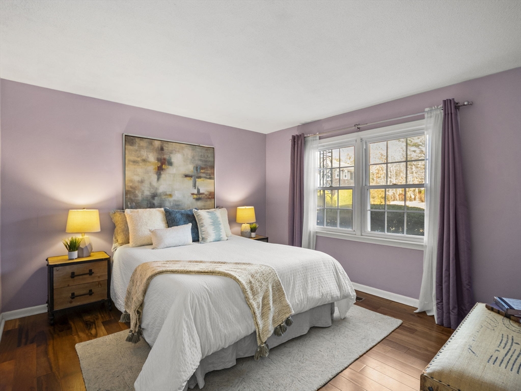 9 Elm Street, Unit 1 Acton, MA 01720 - Photo 14 of 29 a bedroom with a bed and wooden floor