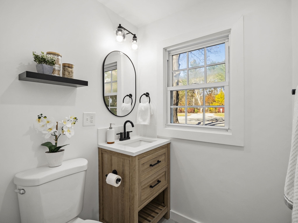 9 Elm Street, Unit 1 Acton, MA 01720 - Photo 18 of 29 a bathroom with a toilet a sink and a window