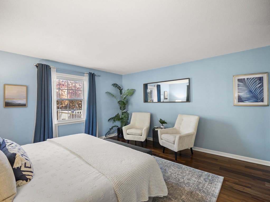 9 Elm Street, Unit 1 Acton, MA 01720 - Photo 21 of 29 a bedroom with a bed and wooden floor