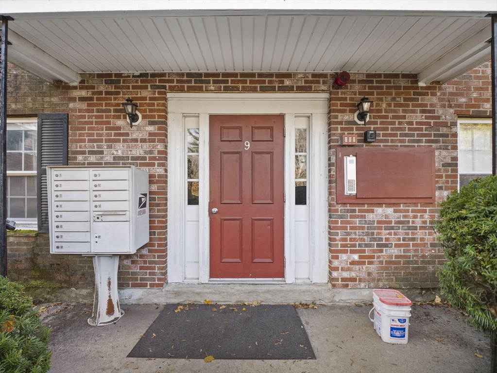 9 Elm Street, Unit 1 Acton, MA 01720 - Photo 27 of 29 a front view of a house with a garage