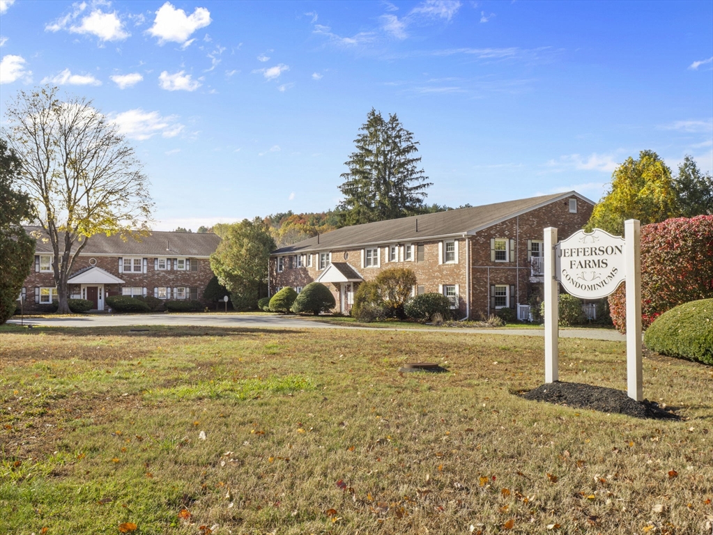 9 Elm Street, Unit 1 Acton, MA 01720 - Photo 29 of 29 a view of an house with backyard space and balcony