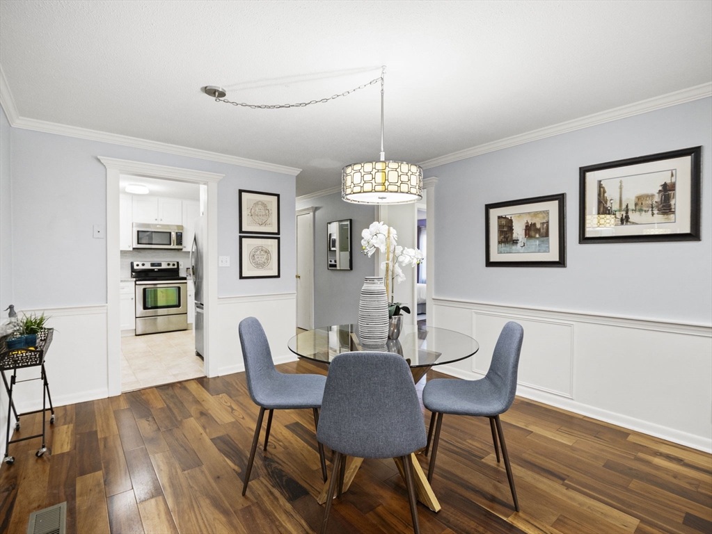 9 Elm Street, Unit 1 Acton, MA 01720 - Photo 5 of 29 a view of a dining room with furniture window and wooden floor
