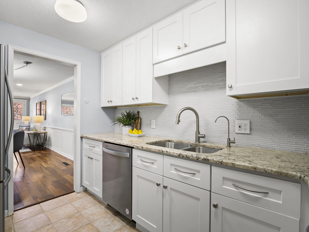 9 Elm Street, Unit 1 Acton, MA 01720 - Photo 8 of 29 a kitchen with sink a stove and cabinets