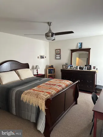 a bedroom with a bed and dresser