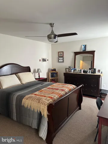 a bedroom with a bed and dresser