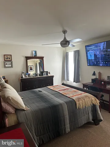 a bedroom with a bed and a dresser