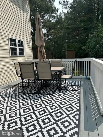 a view of a chairs and table on the deck