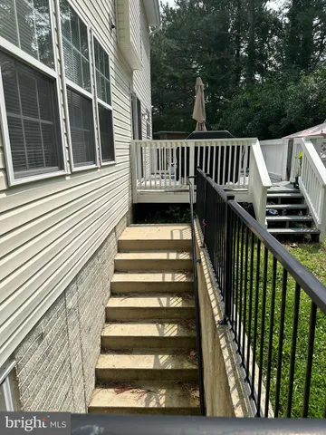 a view of entryway with wooden floor and fence