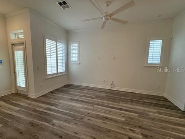 1515 Resolute Street Celebration, FL 34747 - Photo 6 of 39 an empty room with wooden floor fan and windows