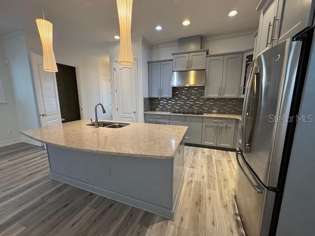 1515 Resolute Street Celebration, FL 34747 - Photo 7 of 39 a kitchen with kitchen island a counter top space a sink a refrigerator and a stove